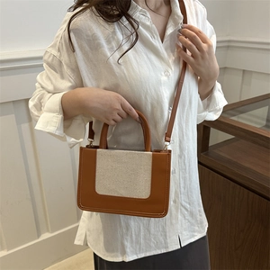 Women's patchwork canvas tote bag with brown leather accents and crossbody strap