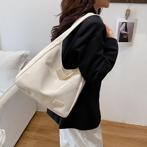 Cream patent leather tote bag for women featuring a minimalist large capacity design