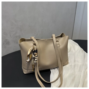 Detail of beige large tote bag in soft PU leather with a printed silk scarf ornament