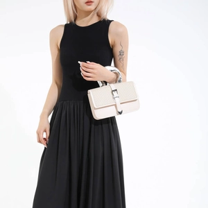 Modern cream leather handbag with silver metal handle and V-shape woven flap detail