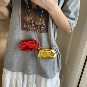 Metallic oval clutch bag with streamline design and chain strap in gold and red