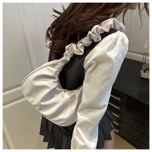 Detail of white pleated cloud shoulder bag with gathered PU leather texture