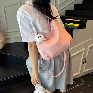 Light pink patent leather tote bag with plush charm and adjustable shoulder strap