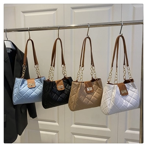 Quilted tote bags in four colors with gold chain straps and metal twist locks