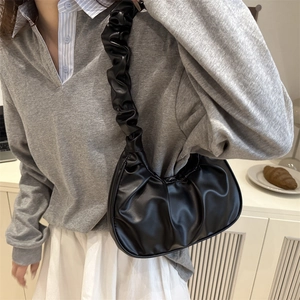 Chic black pleated croissant shoulder bag in glossy leather for women trendy style