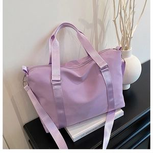 Macro shot of durable lilac oxford cloth travel bag with reinforced straps and zipper