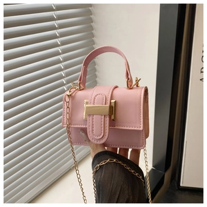 Detail of pink mini square bag featuring glossy finish and elegant gold metal buckle