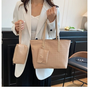 Close-up of three-piece tote bag set with houndstooth texture in beige and khaki tones