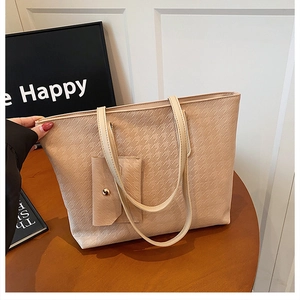 Detail shot of beige tote bag with houndstooth texture and detachable small pouch