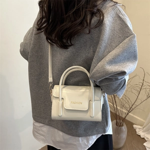 Chic white PU leather crossbody bag with top handle and gold lettering for women