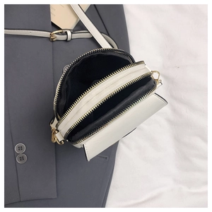 Dual compartment white leather crossbody phone bag with gold zippers and black lining
