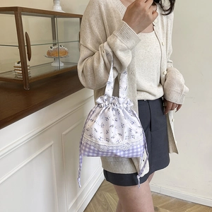 Floral drawstring lunch bag with purple plaid pattern and delicate lace trim detail