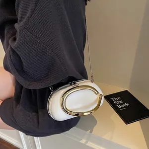 Elegant white oval clutch bag featuring a prominent gold C hardware and chain strap