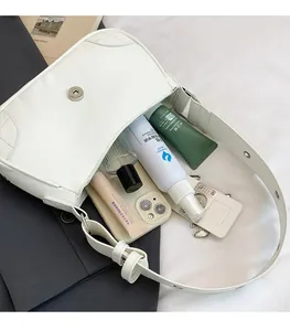 Internal view of a white PU leather shoulder bag showing large storage capacity