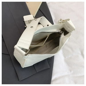 Top view of white PU leather shoulder bag showing spacious interior with two pockets
