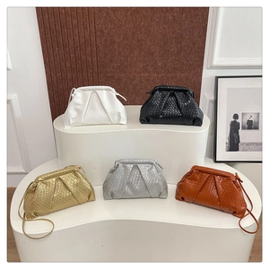 Detailed view of woven texture cloud clutch bags in various colors on display