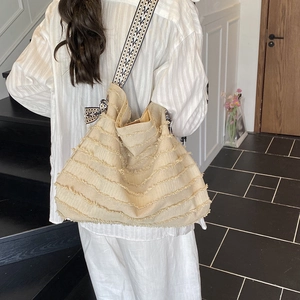 Large vintage beige tote bag with fringe details and geometric strap for women