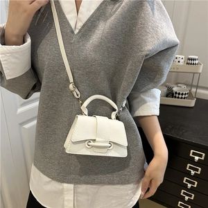 Chic white lychee leather mini crossbody bag with gold buckle and adjustable strap