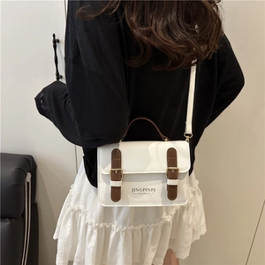 Minimalist white PU leather crossbody bag with brown straps and vintage gold buckles