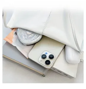 Internal view of a spacious white tote bag showing storage capacity for daily essentials