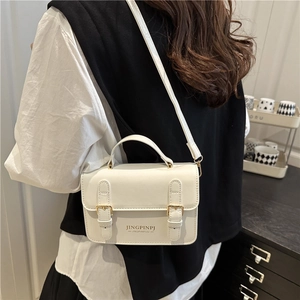 Minimalist white PU leather crossbody bag with dual decorative gold buckles and top handle