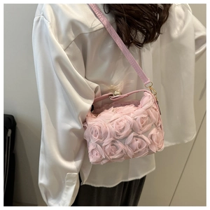 Detail of 3D rose flower petals on soft pink crossbody bag with a metal magnetic clasp