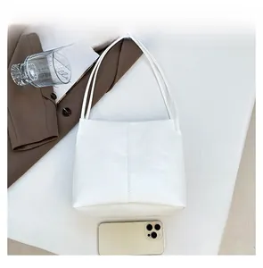 Detail of white PU leather crossbody bag featuring exquisite double stitching craftsmanship