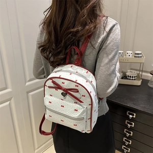Chic women's mini backpack with red bow print and large faux leather heart charm