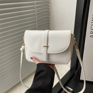 Minimalist white vegetable tanned leather handbag with gold bar and shoulder strap