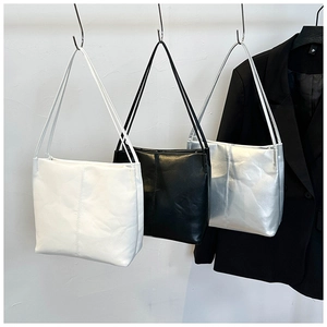 Minimalist square faux leather tote bags in white black and silver shown hanging