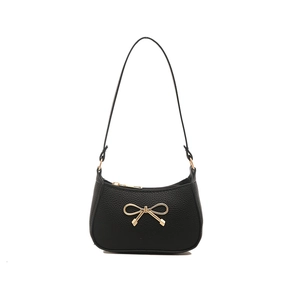 Elegant black hobo shoulder bag with a gold bow accent and high-quality pebble leather texture