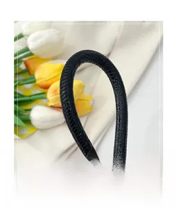 Detail of the black stone pattern texture on the handle of this crescent underarm bag