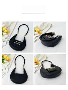 Detailed views of black faux crocodile leather underarm bag with gold buckle