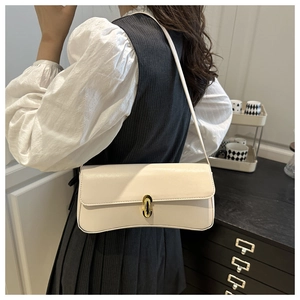 Detail of cream-colored shoulder bag featuring a glossy leather finish and gold oval twist-lock
