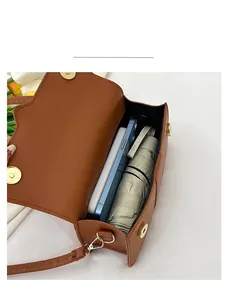 Internal view of brown PU leather shoulder bag showing capacity for phone and umbrella