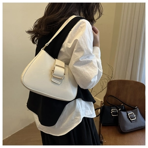 Detail of minimalist leather underarm bags with premium gold buckle in white, black and brown