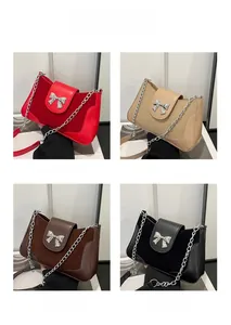 Detail view of stylish saddle bags in four colors with silver metallic bow and chain strap