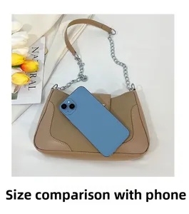 Brown saddle bag size comparison showing the interior fit with a blue smartphone