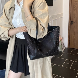 Minimalist black tote bag with white polka dots and large capacity for daily commuting