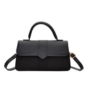 Classic black leather crossbody baguette bag with gold V-buckle and rounded handle