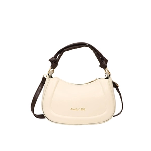 Minimalist cream crescent handbag with brown knotted handle and gold zipper hardware