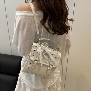 Elegant white floral jacquard crossbody bag with black bow prints and pearl lace charms