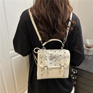 Chic beige lace school backpack for women featuring elegant black bow embroidery and pearls