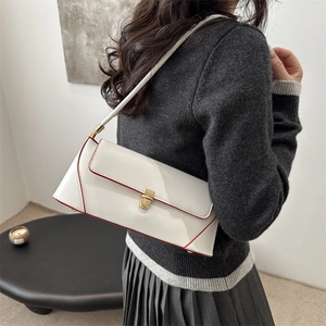 Minimalist white patent leather shoulder bag with gold clasp and red edge accents
