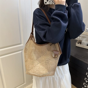 Large mesh straw tote bag with brown leather trim for summer beach vacations and daily use