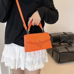 Quilted orange crossbody bag with chevron pattern and stylish gathered handle for women