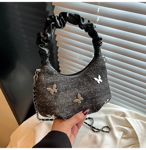 Détail du sac lune gris pailleté avec papillons argentés et poignée froncée noire