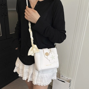 Elegant white crossbody bucket bag with silk bow strap and flower charm for women