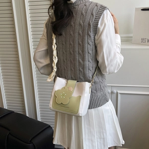 Women's color-block crossbody bucket bag with 3D flower detail and avocado green accents