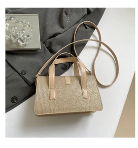 Detailed view of champagne gold sequin handbag with premium texture and metallic shine